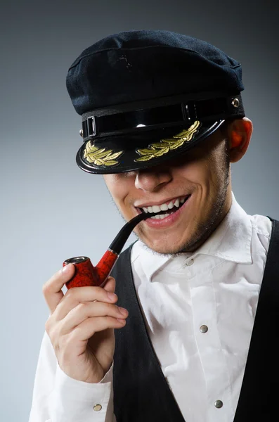 Captain smoking pipe with tobacco — Stock Photo, Image