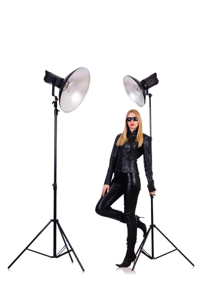 Woman in black leather dress in studio shootout — Stock Photo, Image