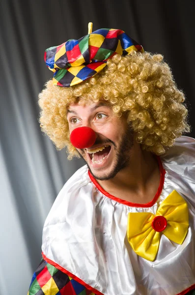Funny clown in humorous concept against curtain — Stock Photo, Image