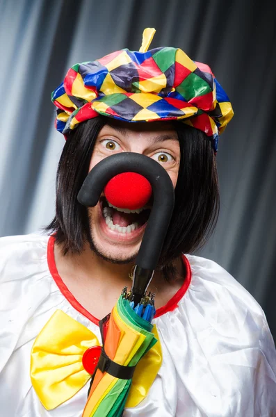 Funny clown with colourful umbrella — Stock Photo, Image