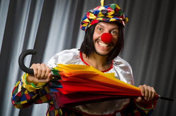 Funny clown with colourful umbrella — Stock Photo, Image