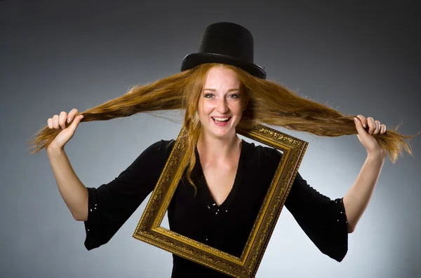 Woman with vintage hat and picture frame — Stock Photo, Image