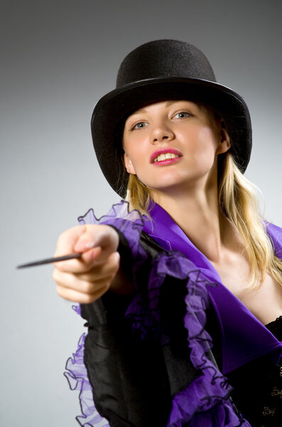 Woman magician doing her tricks with wand