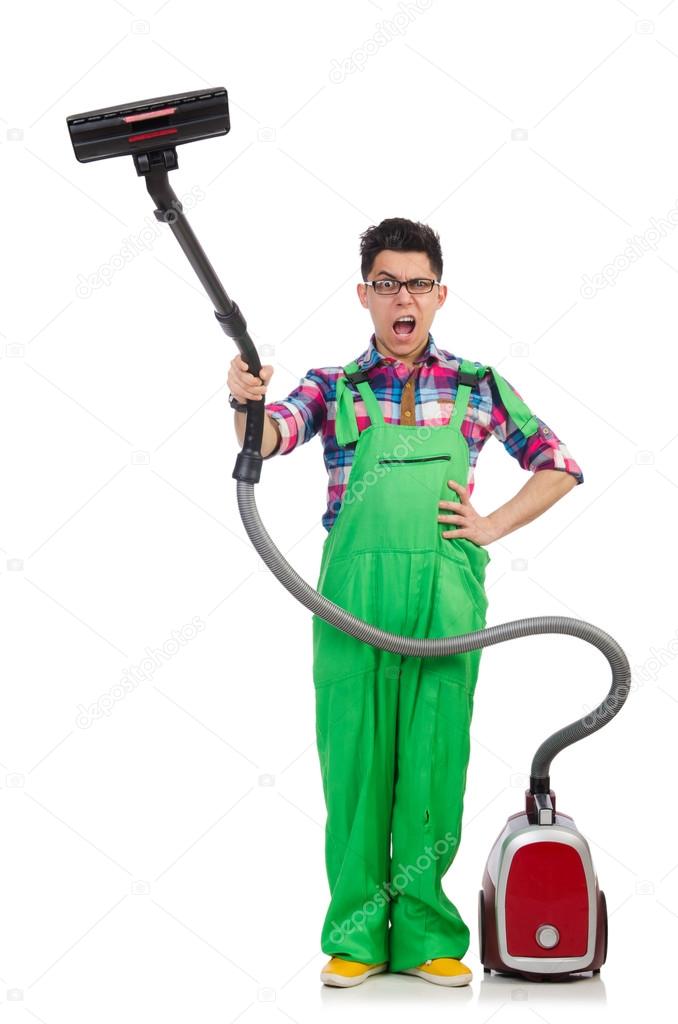 Funny man in green coveralls vacuum cleaning