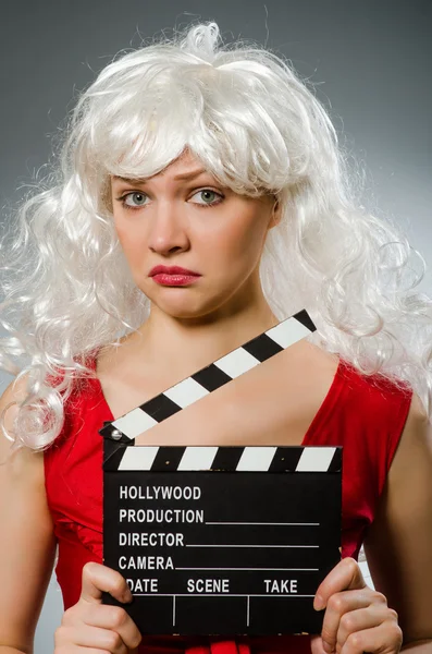 Blond woman with movie board — Stock Photo, Image