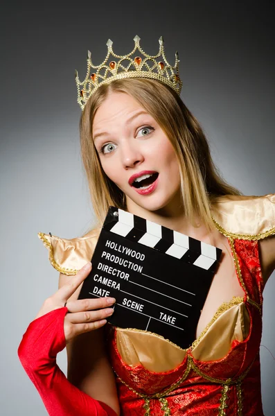 Queen in red dress with movie clapboard — Stock Photo, Image