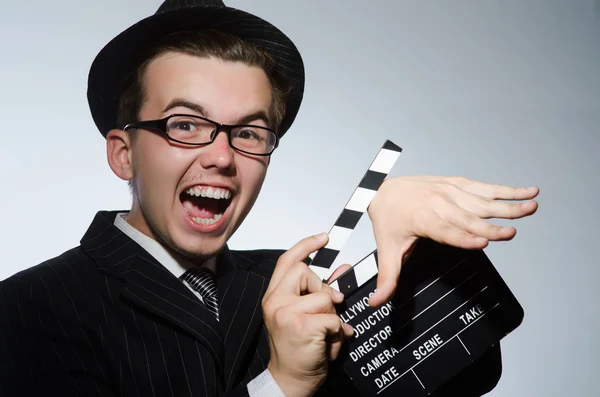 Man with movie clapperboard and hat — Stock Photo, Image