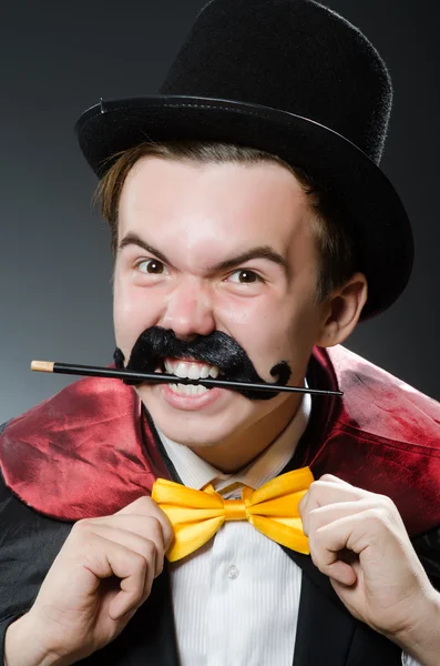 Funny magician with wand and hat — Stock Photo, Image