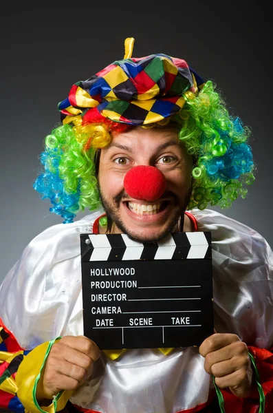 Clown with movie clapper board — Stock Photo, Image