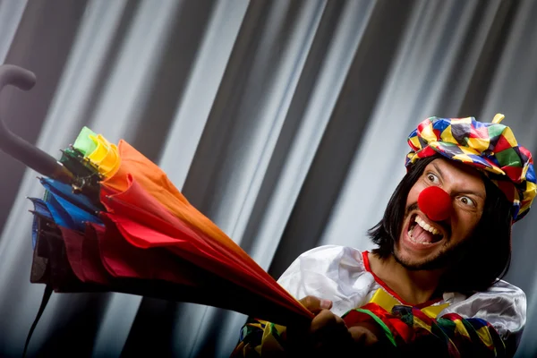 Funny clown with colourful umbrella — Stock Photo, Image