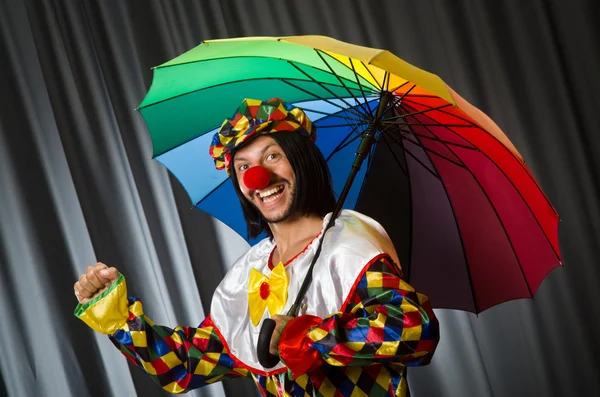 Funny clown with colourful umbrella — Stock Photo, Image