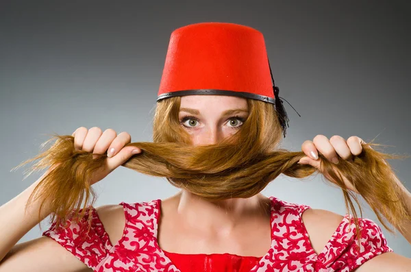 Woman wearing red fez hat — Stock Photo, Image