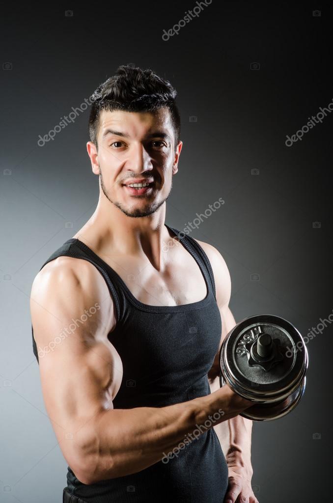 Muscular ripped bodybuilder with dumbbells Stock Photo by ©Elnur_ 53840407