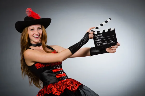 Vrouw in piratenkostuum met filmbord — Stockfoto