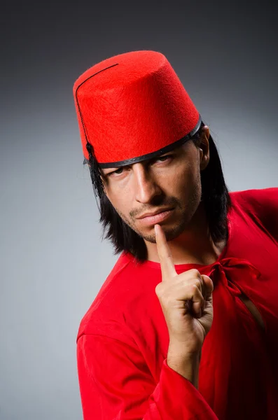 Man in red dress wearing fez hat — Stock Photo, Image