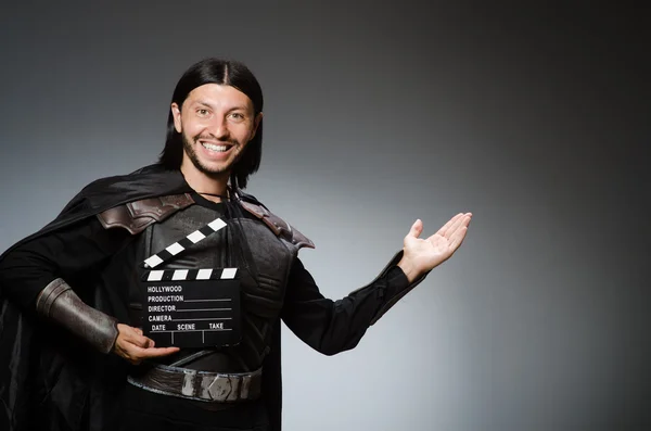 Knight with the movie board clapperboard — Stock Photo, Image