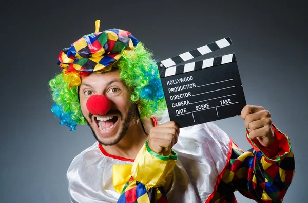 Clown with movie clapper board — Stock Photo, Image