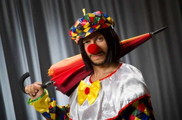 Funny clown with colourful umbrella — Stock Photo, Image