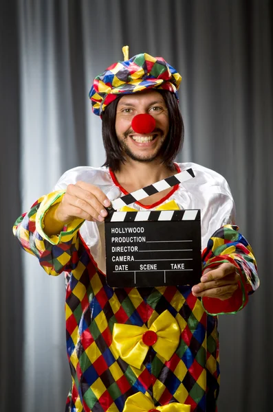 Clown with movie clapper board — Stock Photo, Image