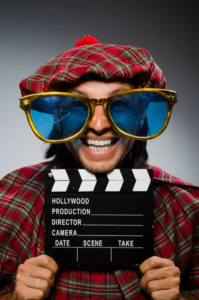 Funny scotsman with movie clapboard — Stock Photo, Image