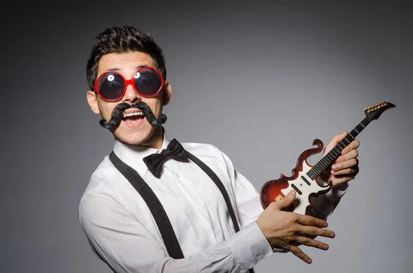 Funny man with mini guitar — Stock Photo, Image