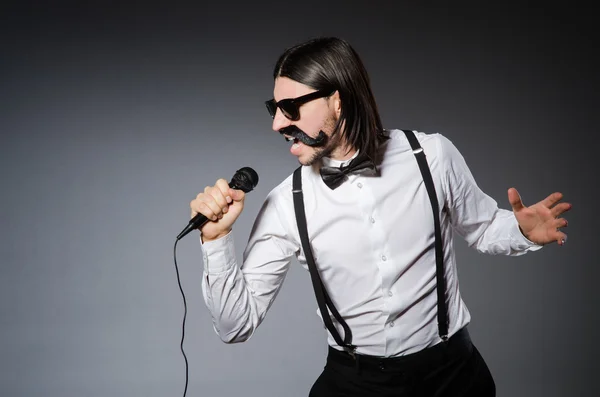 Забавный певец с микрофоном на концерте — стоковое фото