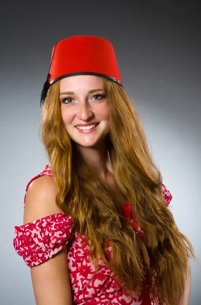 Woman wearing red fez hat — Stock Photo, Image