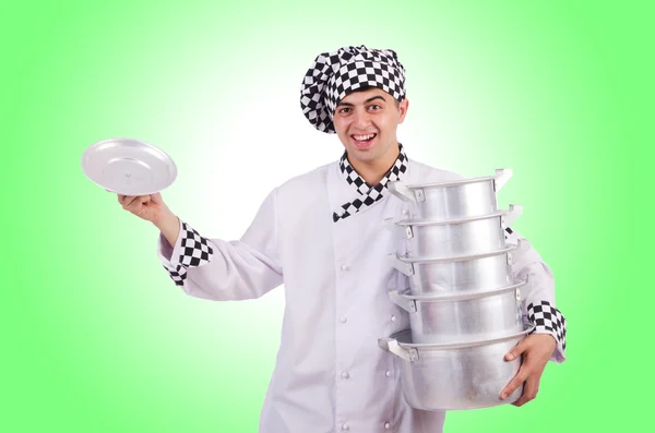 Cook with stack of pots on white — Stock Photo, Image