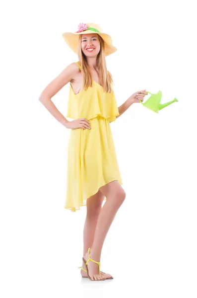 Vrouw in gele jurk met gieter — Stockfoto
