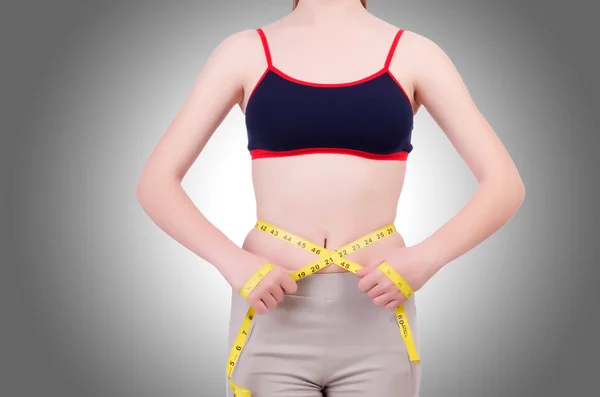 Young girl with centimeter in dieting concept — Stock Photo, Image