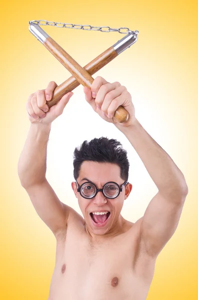 Chico divertido con nunchucks en blanco — Foto de Stock