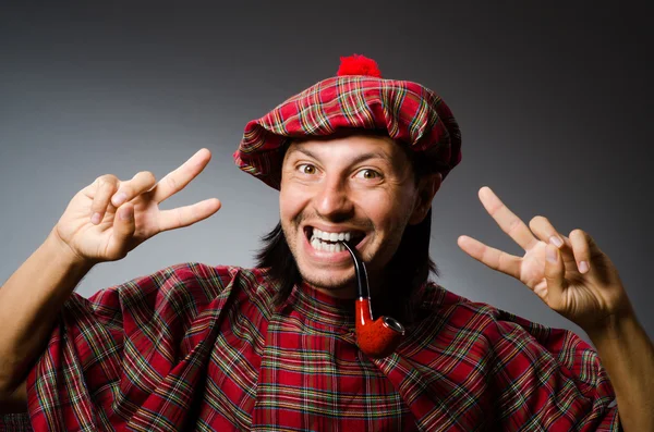 Funny scotsman with smoking pipe — Stock Photo, Image