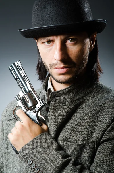 Man with gun and vintage hat