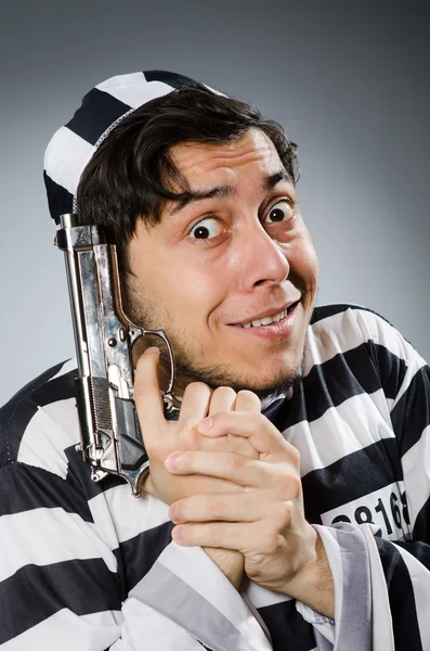 Funny prison inmate with gun — Stock Photo, Image