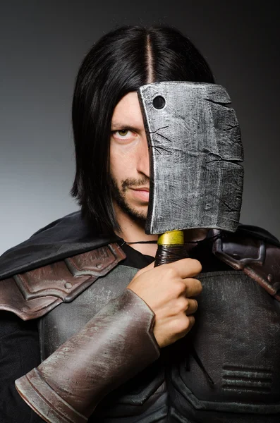 Knight with axe against dark background — Stock Photo, Image