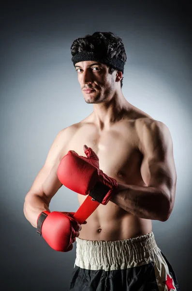 Muscular boxer with red gloves — Stock Photo, Image