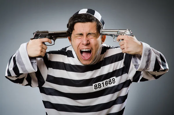 Funny prison inmate with gun — Stock Photo, Image