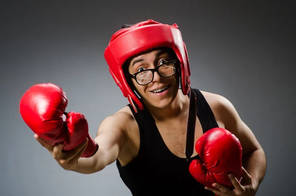 Funny boxer with red gloves against dark background — Stock Photo, Image