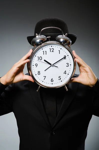 Man with clock wearing vintage hat — Stock Photo, Image