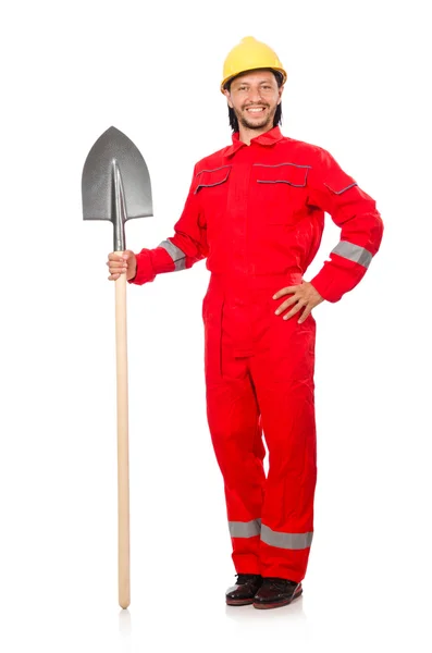 Человек в красном комбинезоне с лопатой — стоковое фото