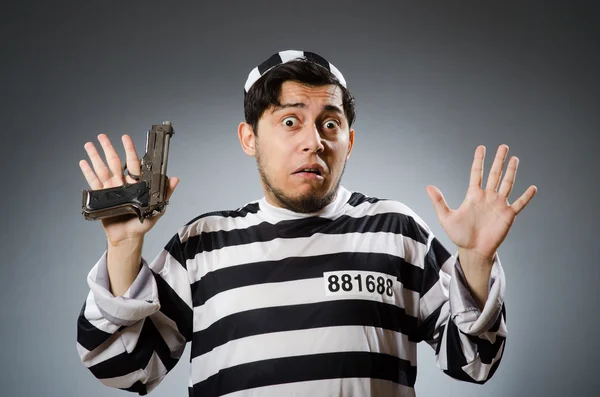 Funny prison inmate with gun — Stock Photo, Image