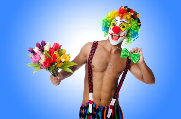 Clown with flowers on white — Stock Photo, Image