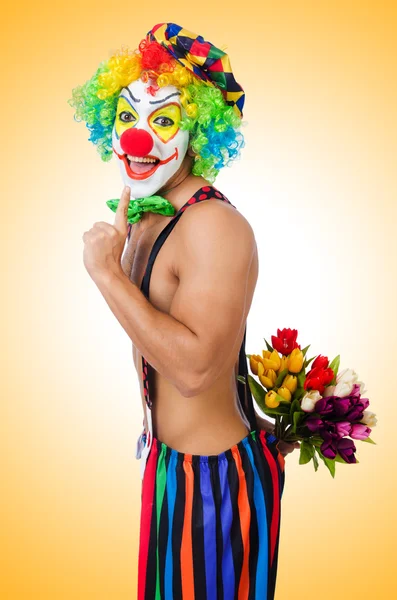 Clown with flowers on white — Stock Photo, Image