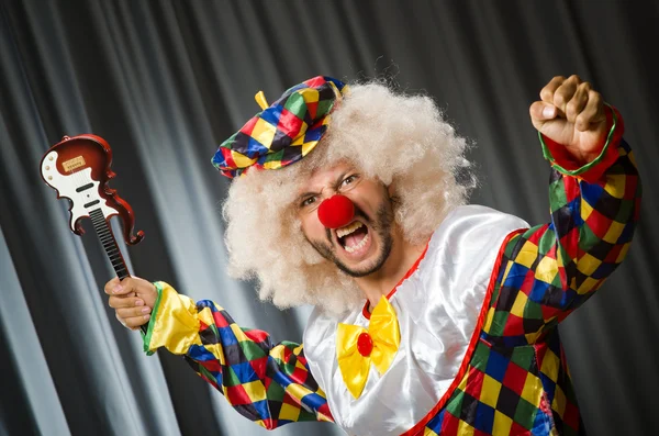 Wütender Clown mit Gitarre in lustigem Konzept — Stockfoto