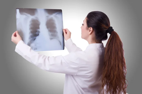 Woman doctor examining x-ray — Stock Photo, Image