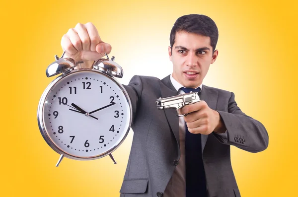 Man with gun and clock — Stock Photo, Image