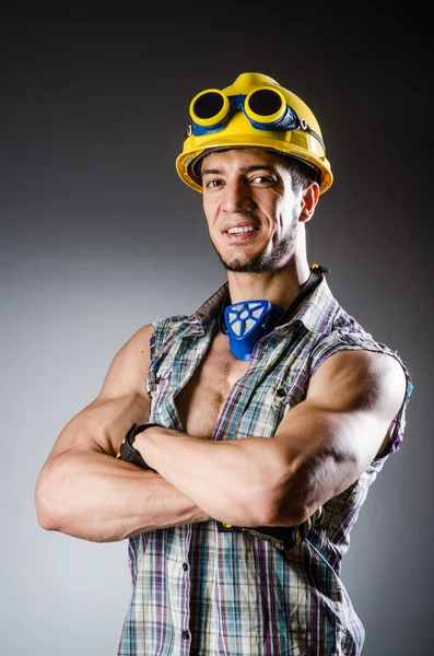 Ripped muscular builder man with tools — Stock Photo, Image