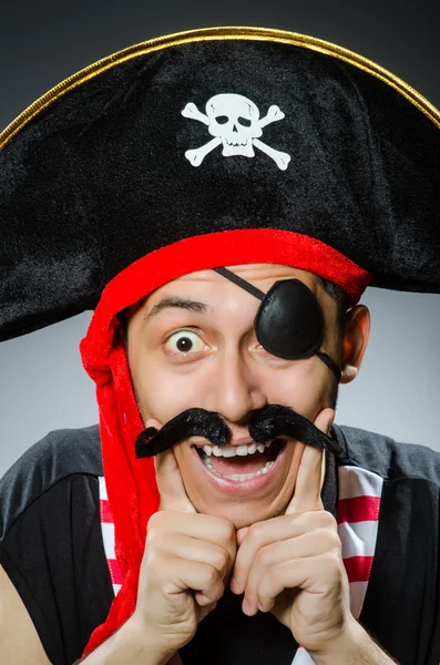 Funny pirate in the dark studio — Stock Photo, Image