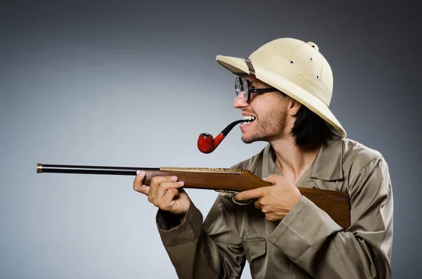 Hunter with rifle and smoking pipe — Stock Photo, Image