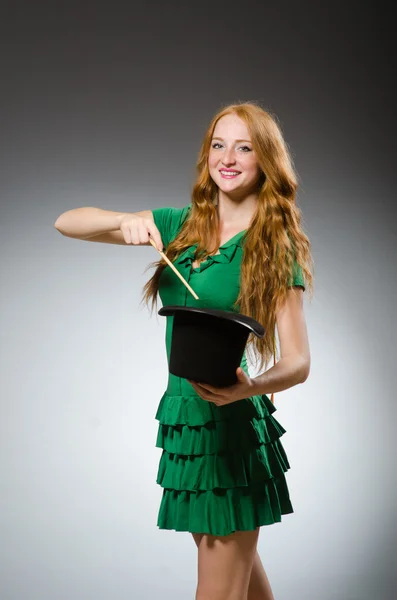 Woman magician wearing green dress — Stock Photo, Image